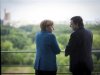 German Chancellor Merkel speaks with European Commission President Barroso at the start of their meeting at the Chancellery in Berlin