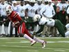 Louisville's DeVante Parker, left, outruns the grasp of South Florida's George Baker during action of their NCAA colege football game Saturday Oct. 20, 2012 in Louisville, Ky.  Louisville defeated USF 27-25. (AP Photo/Timothy D. Easley)