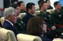 US Secretary of Defense Chuck Hagel (L) watches a short film about the Non-Commissioned Officer Academy during a visit to Beijing on April 9, 2014