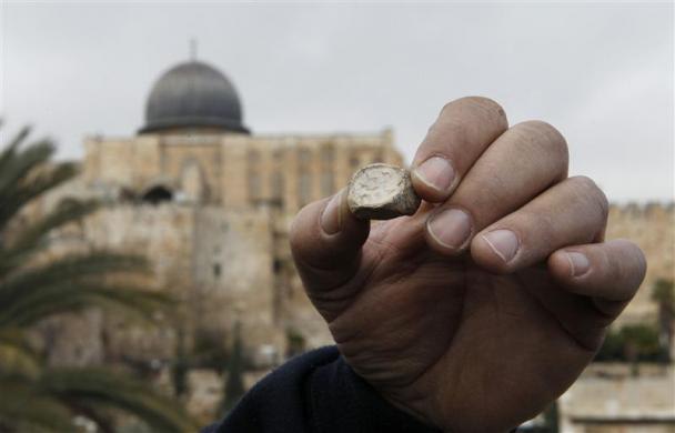Arkeolog Israel Eli Shukron menunjukkan cap kuno di Yerusalem, 25 Desember 2011. Cap tanah liat berusia 2000 tahun ini mengonfirmasikan adanya ritual yang dilakukan di tempat ibadah orang Yahudi.