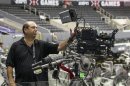 In this Wednesday, June 27, 2012, photo, ESPN coordinating producer Phil Orlins shows a 3-D camera set up used by ESPN 3-D Network coverage at the ESPN X-Games held at the Staples Center in Los Angeles. Only 2 percent of TVs in American homes were able to show 3-D last year, according to IHS Screen Digest. That's about 6.9 million sets out of 331 million installed. (AP Photo/Damian Dovarganes)