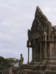 A temple guard stands guard at the famed Preah Vihear temple near Cambodia-Thai border in Preah Vihear Province, Cambodia, Sunday, Nov. 10, 2013. The International Court of Justice rules on a dispute between Cambodia and Thailand over land surrounding the 1,000-year-old temple on Monday. (AP Photo/Heng Sinith)