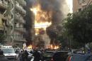 Fire and smoke is seen at the site of the explosion in Beirut's southern suburbs