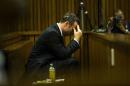 Oscar Pistorius sits in dock during court proceedings at the North Gauteng High Court in Pretoria
