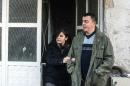 Noora Arkavazi and her husband Bobi Dodevski leave their building in Kumanovo, Macedonia