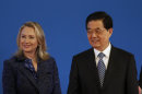 U.S. Secretary of State Hillary Rodham Clinton, left, stands with Chinese President Hu Jintao during the opening ceremony of the U.S.- China Strategic and Economic Dialogue at the Diaoyutai state guesthouse in Beijing Thursday, May 3, 2012. (AP Photo/Vincent Thian)