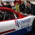 Romney autographs a racecar at the Federated Auto Parts 400 NASCAR Sprint Cup Series race in Richmond