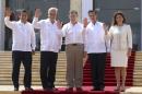 Leaders attending the VIII Pacific Alliance Summit wave as they pose for an official group photo, from left to right, Peru's President Ollanta Humala, Chile's President Sebastian Pinera, Colombia's President Juan Manuel Santos, Mexico's President Enrique Pena Nieto and Costa Rica's Laura Chinchilla in Cartagena, Colombia, Monday, Feb. 10, 2014. (AP Photo/Pedro Mendoza)