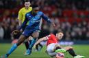Arsenal's striker Danny Welbeck (L) vies with Manchester United's midfielder Michael Carrick (R) during the FA Cup quarter-final football match at Old Trafford on March 9, 2015
