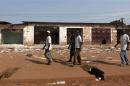 Men walk past looted stores belonging to Muslims in Combattant district in Bangui