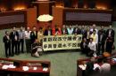 Pro-democracy lawmakers chant slogans after voting at Legislative Council in Hong Kong