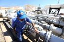 A Libyan oil worker checks oil pipelines at the Zawiya oil installation on August 22, 2013