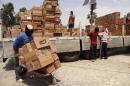Some 80 tons of food aid donated is off loaded after it arrived in the northern Iraqi city of Kirkuk, on July 5, 2014, where displaced people have taken refuge