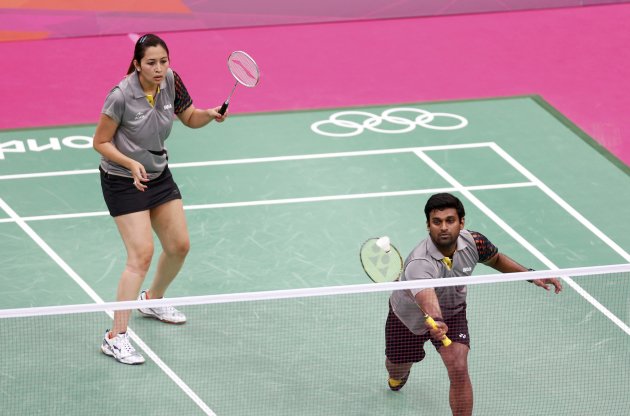 India's Diju V and Jwala Gutta play against Denmark's Thomas Laybourn and Kamilla Rytter Juhl during their mixed doubles group play stage badminton match at the Wembley Arena during the London 2012 Ol