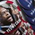 Campaign buttons for Republican Presidential candidate Herman Cain are seen on sale as he campaigned in Talladega, Ala., Friday, Oct. 28, 2011. (AP Photo/Dave Martin)