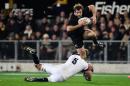 New Zealand All Blacks player Conrad Smith (R) is tackled by England's Geoff Parling during their second rugby union Test match, in Dunedin, on June 14, 2014