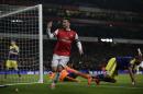 Arsenal's Olivier Giroud celebrates scoring his side's second goal during the English Premier League soccer match between Arsenal and Swansea City at the Emirates Stadium in London, Tuesday, March 25, 2014. (AP Photo/Matt Dunham)