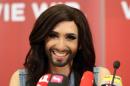 Austrian singer Conchita Wurst attends a press conference in Vienna, Austria Sunday May 11, 2014. Bearded drag queen Conchita Wurst has made a triumphant return to Austria after winning the Eurovision Song Contest in Copenhagen Saturday, in what the country's president called a victory for tolerance in Europe. (AP Photo/Ronald Zak)