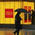 File photo of a man walking past a Wells Fargo Bank branch on a rainy morning in Washington