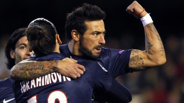 Paris Saint-Germain's Argentine player Ezequiel Lavezzi (R) gestures as he is embraced by teammate Zlatan Ibrahimovic after scoring a goal against Valencia during their Champions League soccer match at Mestalla stadium, in Valencia February 12, 2013