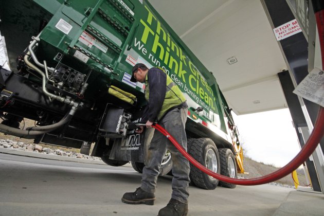 In this Nov. 19, 2012 photo, Waste Management driver Alan Sadler fills his truck with CNG gas at the company's filling station in Washington, Pa. Years from now, motorists needing a fill-up might see natural gas pumps sharing space at the neighborhood filling station with ones dispensing gasoline and diesel. (AP Photo/Gene J. Puskar)