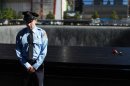 A policeman who lost a family member in the 9/11 attacks observes a moment of silence.