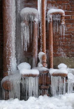 FILE - In this Feb. 3, 2011 file photo, ice coats leaking pipes in a downtown Cleveland alley, in Ohio. With much of the nation gripped in record cold at some point this winter, homeowners have had to deal with pipes freezing, and then bursting. Damage from a burst pipe can vary greatly, depending on the amount of time that the water runs unabated. (AP Photo/Mark Duncan, File)