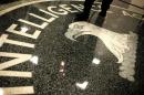 A man walks across the seal of the Central Intelligence Agency at the lobby of the original headquarters building in McLean, Virginia, February 19, 2009