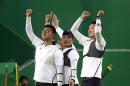 From left South Korea's Kim Woo-jin, Lee Seung-yun, and Ku Bon-chan, celebrate after winning the men's team archery gold medal match at the Sambadrome venue during the 2016 Summer Olympics in Rio de Janeiro, Brazil, Saturday, Aug. 6, 2016. (AP Photo/Alessandra Tarantino)