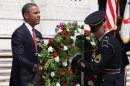 US President Barack Obama (L) positions a commemorative wreath during a ceremony on Memorial Day
