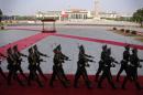 Soldiers from the honour guards of the Chinese People's Liberation Army march in front of the Monument to the People's Heroes at Tiananmen Square in Beijing