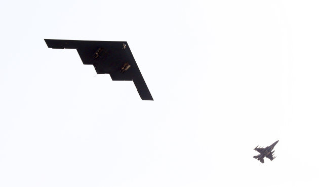 U.S. Air Force B-2 stealth bomber, left, flies over near Osan U.S. Air Base in Pyeongtaek, south of Seoul, South Korea, Thursday, March 28, 2013. A day after shutting down a key military hotline, Pyongyang instead used indirect communications with Seoul to allow South Koreans to cross the heavily armed border and work at a factory complex that is the last major symbol of inter-Korean cooperation. (AP Photo/Lee Jung-hun, Yonhap) KOREA OUT