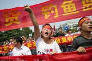 A demonstrator shouts slogans during a protest against Japan's "nationalising" of Diaoyu Islands on Septermber 18 in China. Toyota and Nissan are reducing production in China because demand for Japanese cars has been hit by an island row, officials said Wednesday