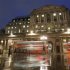 Busses pass the Bank of England in the city of London