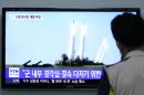 A man watches a TV news program showing the missile launch conducted by North Korea, at Seoul Railway Station in Seoul, South Korea, Thursday, June 26, 2014. North Korea fired three short-range projectiles Thursday into the waters off its east coast, a South Korean defense official said. The move was most likely a routine test-firing, but the official said it could also be meant to stoke tensions with Seoul. The writing on tje screen reads "The missiles were launched to alert and express its internal solidarity." (AP Photo/Ahn Young-joon)