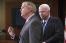 FILE - In this Feb. 24, 2016, file photo, Republican members of the Senate Armed Services Committee, Sen. Lindsey Graham, R-S.C., center, and committee chairman John McCain, R-Ariz., speak at a news conference on Capitol Hill in Washington. Graham and McCain are assembling a harsh critique of Donald Trump's worldview by soliciting rebuttals from U.S. military leaders that challenge the accuracy and legality of his most provocative foreign policy positions. (AP Photo/J. Scott Applewhite, File)