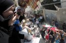 Palestinian mourners cry during a funeral in the West Bank city of Jenin on August 20, 2013