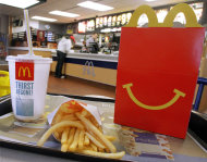 <p> In this Jan. 20, 2012 photo, the McDonald's logo and a Happy Meal box with french fries and a drink are posed at McDonald's, in Springfield, Ill. McDonald’s Corp. reports quarterly earnings on Monday, July 22, 2013. (AP Photo/Seth Perlman)