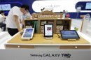 Samsung Electronics' Galaxy Tabs tablet computers are displayed at the company's shop in Seoul, South Korea, Friday, July 27, 2012. Samsung, the world's largest technology company by revenue, reported another record-high quarterly profit as customers flocked to Galaxy smartphones, helping it outdo rivals at a challenging time for the global tech industry. Samsung Electronics Co.'s net profit swelled to 5.2 trillion won ($4.5 billion) in the April-June quarter, a 48 percent jump from a year earlier. (AP Photo/Ahn Young-joon)