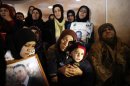 Relatives mourn during the funeral of Palestinian prisoner Arafat Jaradat in the West Bank village of Se'eer, near Hebron