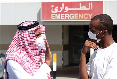 Men wearing surgical masks as a precautionary measure against the novel coronavirus, speak at a hospital in Khobar city in Dammam May 23, 2013. REUTERS/Stringer