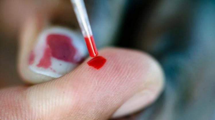 A blood test is carried out at a roadside AIDS testing table in Langa, a suburb of Cape Town on International AIDS Day on December 01, 2010