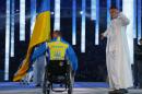 Biathlete Mykhaylo Tkachenko, representing Ukraine, enters the arena during the opening ceremony of the 2014 Winter Paralympics at the Fisht Olympic stadium in Sochi, Russia, Friday, March 7, 2014. (AP Photo/Dmitry Lovetsky)