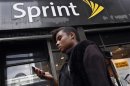 A woman uses her phone as she walks past a Sprint store in New York's financial district in this file photo