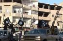 A member of the Islamic state militant group parades in a street in the northern rebel-held Syrian city of Raqa