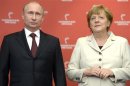 German Chancellor Merkel and Russian President Putin pose before officially opening Hanover Messe in Hanover