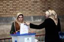 An Iraqi woman residing in Iran casts her ballot for Iraq's parliamentary elections at a polling station in southern Tehran on April 27, 2014