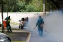 A truck sprays insecticide around Olympic media accomodations in Rio de Janeiro