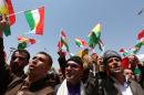 Iraqi Kurdish protesters wave flags of their autonomous Kurdistan region during a demonstration to claim for its independence on July 3, 2014 outside the Kurdistan parliament building in Arbil, in northern Iraq