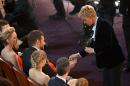 Ellen DeGeneres, right, gives Bradley Cooper a lottery ticket during the Oscars at the Dolby Theatre on Sunday, March 2, 2014, in Los Angeles. (Photo by John Shearer/Invision/AP)